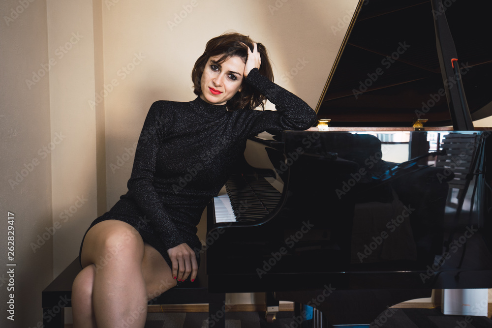 Young woman playing a piano at home Young woman playing a piano at home