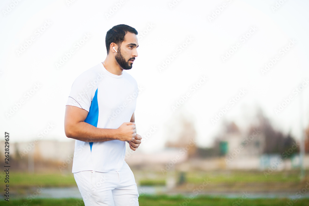 Fitness. Young man running in urban environment Fitness. Young man running in urban environment