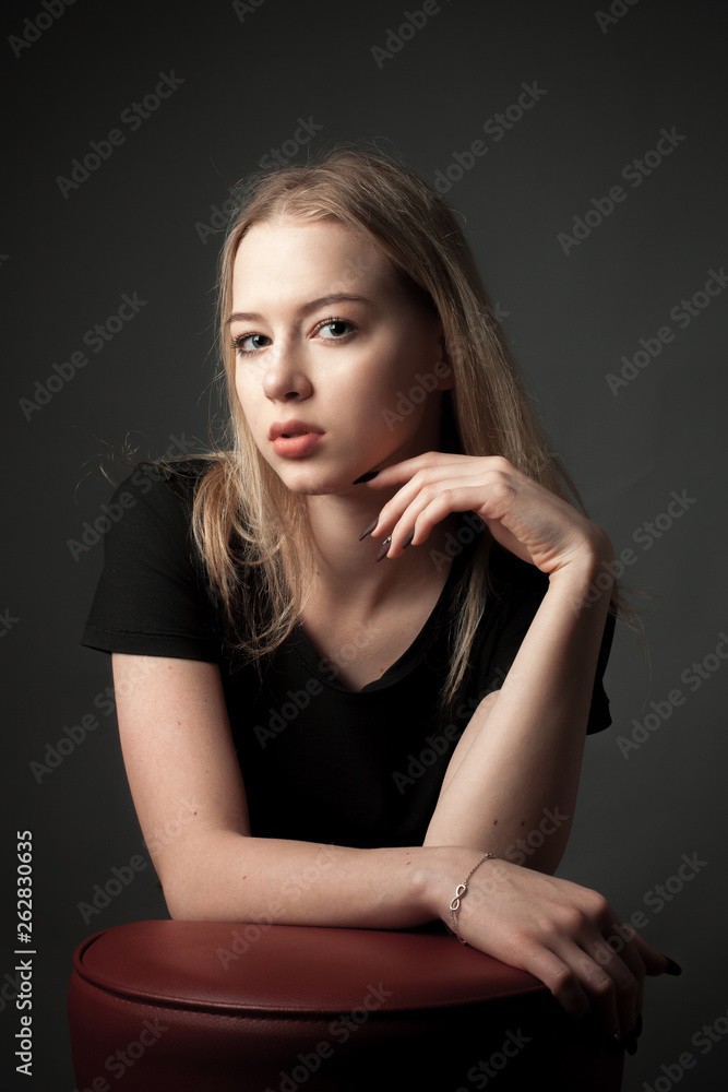 Portrait of the blonde young woman on black background. Portrait of the blonde young woman on black background.