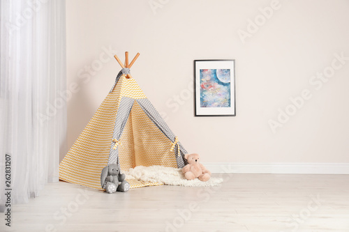 Cozy child room interior with play tent near window © New Africa