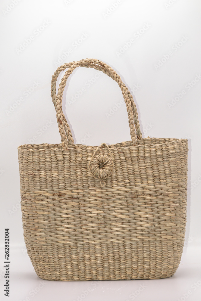 Wickerwork woman bag texture made from dry sedge isolate on white background.Closeup surface texture of hand made craft work papyrus sedge. Wickerwork woman bag texture made from dry sedge isolate on white background.Closeup surface texture of hand made craft work papyrus sedge.