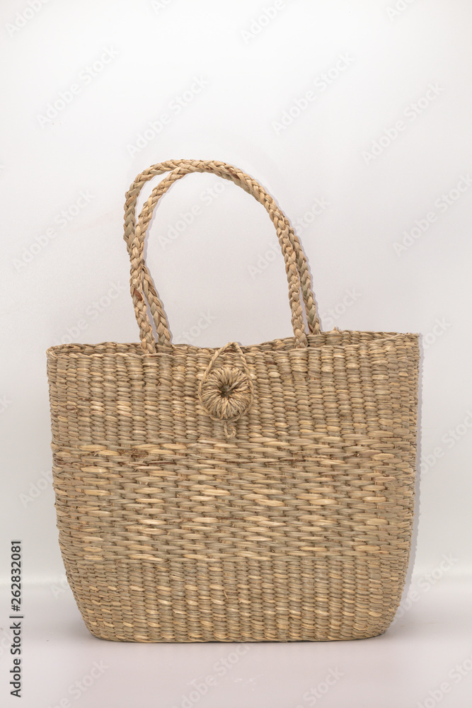 Wickerwork woman bag texture made from dry sedge isolate on white background.Closeup surface texture of hand made craft work papyrus sedge. Wickerwork woman bag texture made from dry sedge isolate on white background.Closeup surface texture of hand made craft work papyrus sedge.