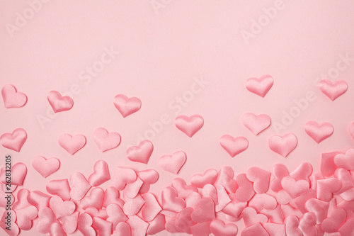 elements in shape of heart flying on pink background. symbols of love for Happy Women's, Mother's, Valentine's Day