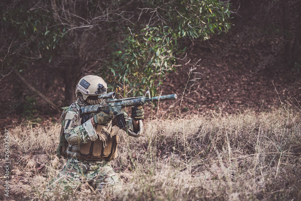 Military camouflage to find opportunities to shoot enemies in the grass,soldier war concept Military camouflage to find opportunities to shoot enemies in the grass,soldier war concept