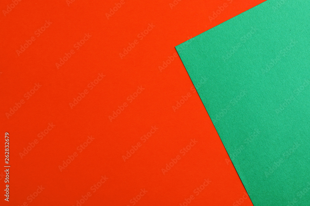 Green and red paper sheets as colorful background, top view Green and red paper sheets as colorful background, top view