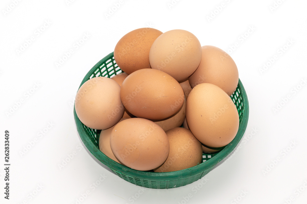 Close up eggs in a green basket isolate on white background. Select focus. Close up eggs in a green basket isolate on white background. Select focus.