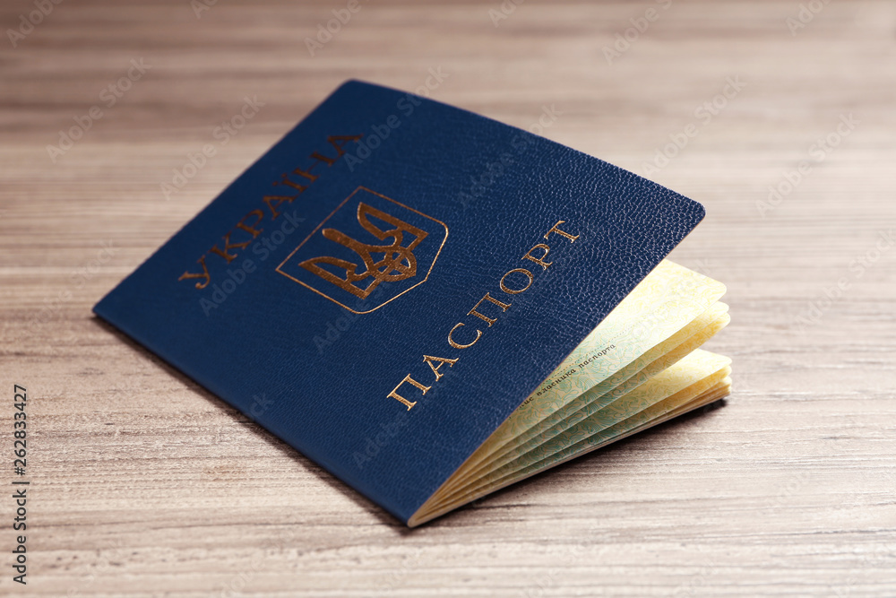 Ukrainian internal passport on wooden background, closeup Ukrainian internal passport on wooden background, closeup
