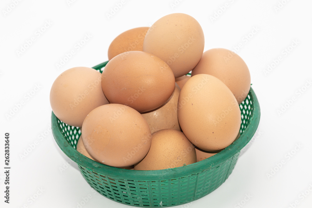 Close up eggs in a green basket isolate on white background. Select focus. Close up eggs in a green basket isolate on white background. Select focus.