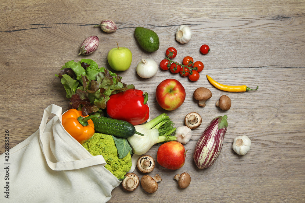 Bag with fresh vegetables and fruits on wooden background, flat lay Bag with fresh vegetables and fruits on wooden background, flat lay