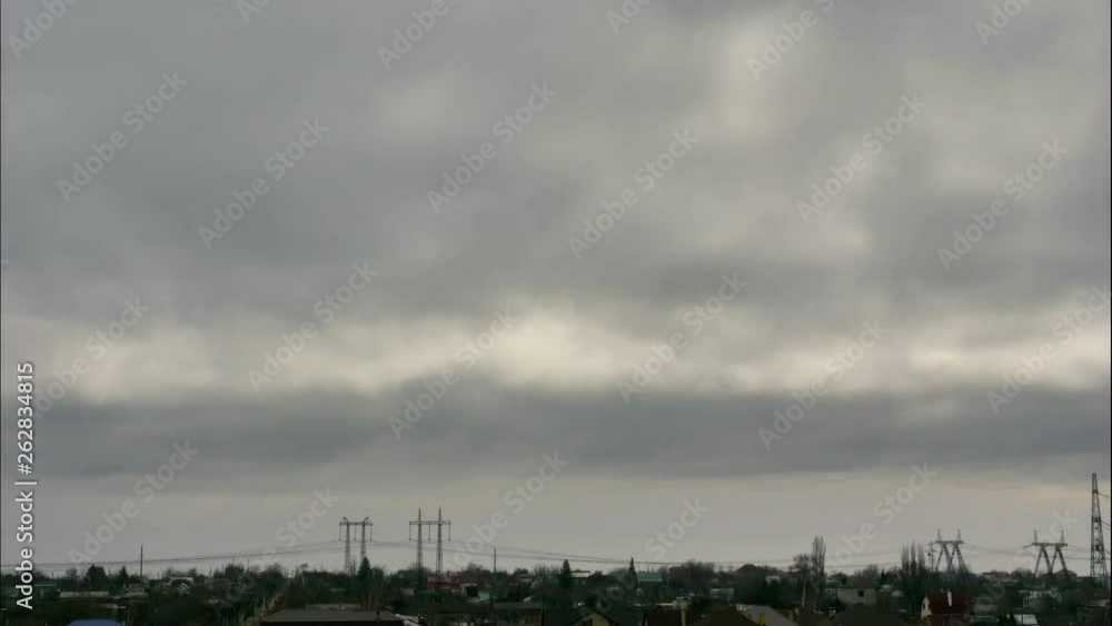Panorama of the industrial zone, which is located behind the river. A thick fog that gradually fades over the surface of the water. Sky in thunder clouds. In the foreground is a village.Timelapse Panorama of the industrial zone, which is located behind the river. A thick fog that gradually fades over the surface of the water. Sky in thunder clouds. In the foreground is a village.Timelapse