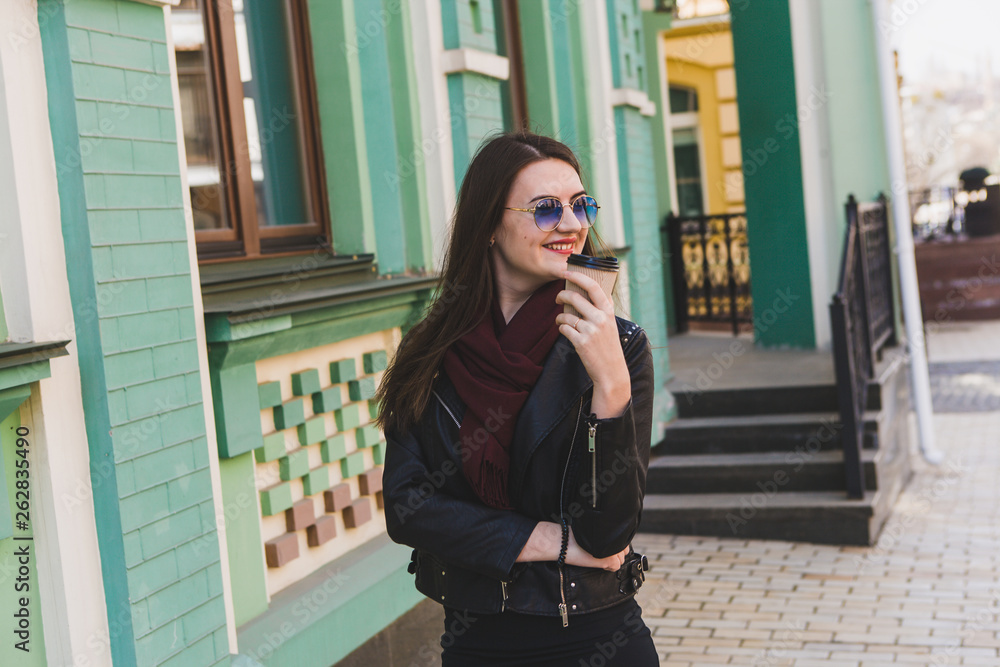 Fototapeta premium beautiful woman walking in the city enjoying delicious coffee