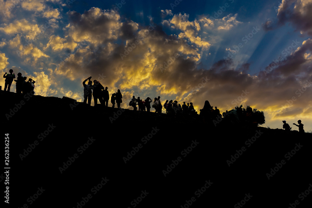 Group of happy children playing on hill at sunset, silhouette Group of happy children playing on hill at sunset, silhouette
