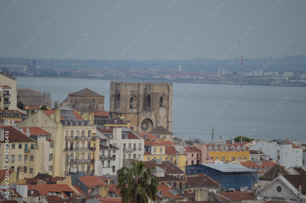 Wonderful views of the Cathedral of Lisbon from the XII Century From The Garden San Pedro De Alcantara In Lisbon. Nature, architecture, history, street photography. April 11, 2014. Lisbon, Portugal.