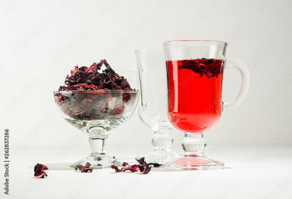 Transparent glass Cup with hot red tea from hibiscus or hibiscus. Transparent glass Cup with hot red tea from hibiscus or hibiscus.
