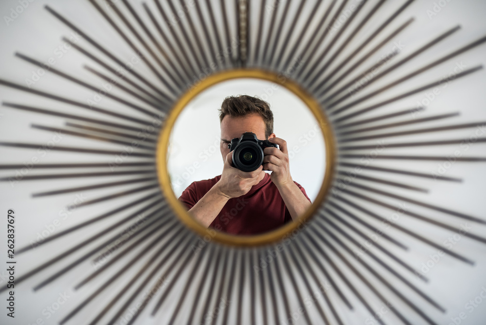 Obraz premium Man with camera taking picture of reflection