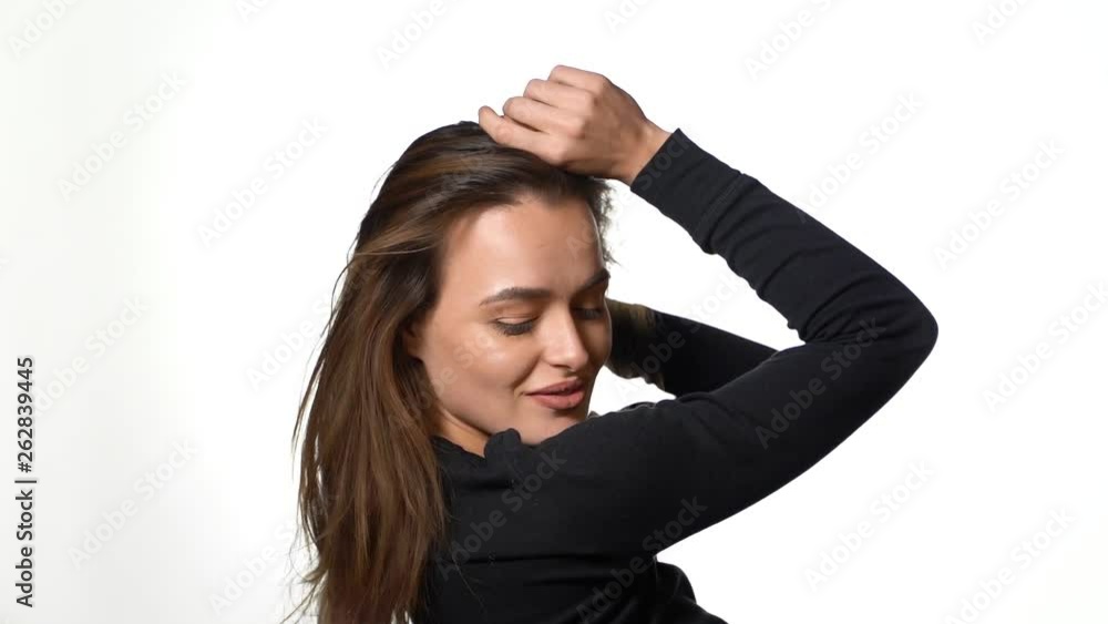 Smiling positively and being in great mood while standing over white background