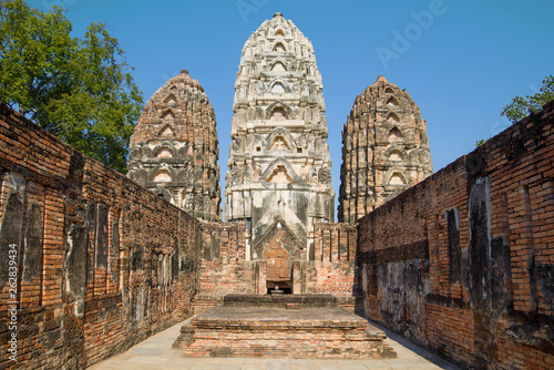 On the ruins of the ancient Khmer temple of Wat Sri Sawai. Historical Park of Sukhothai, Thailand