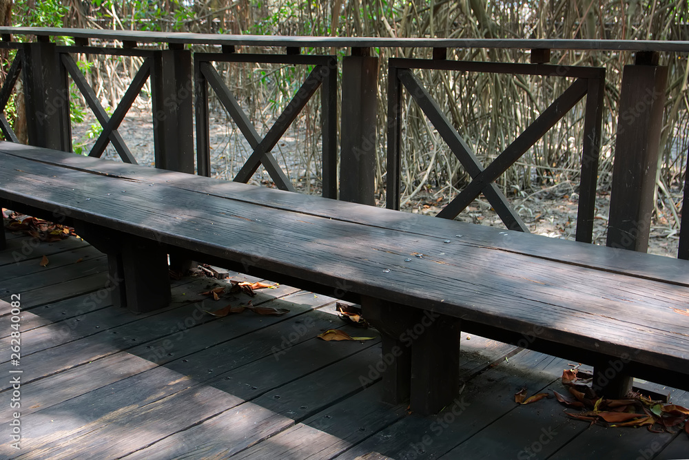 Wooden bank. Mangrove forest at background