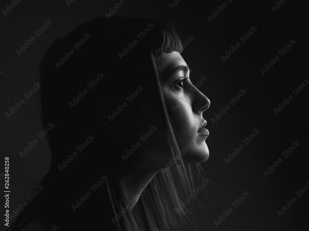 Pensive woman in profile. Black and white