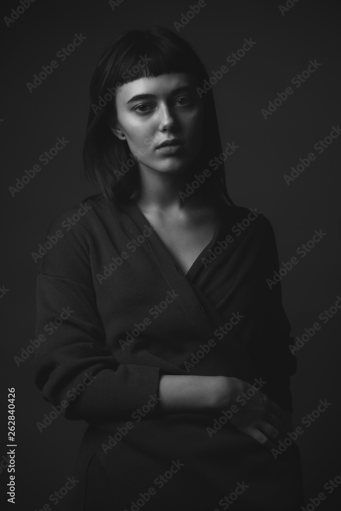 Young woman posing in studio. Black and white. Low key Young woman posing in studio. Black and white. Low key