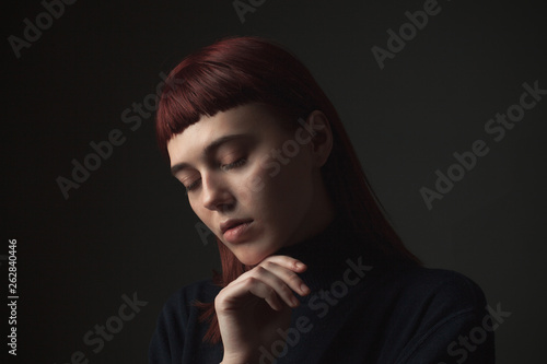 Portrait of calm young woman. Low key