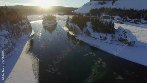 aerial video of yukon river near the area of five finger rapids Yukon in winter with the sun on the horizon photo