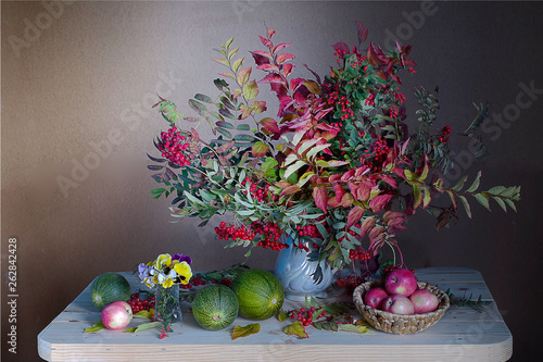 A bouquet of colorful leaves and red berries in autumn.Autumn still-life with beautiful autumn leaves .