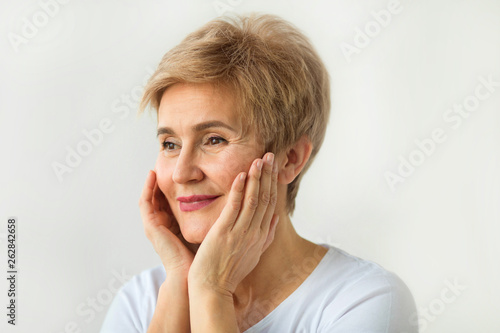 stylish beautiful elderly woman with short haircut on a white background
