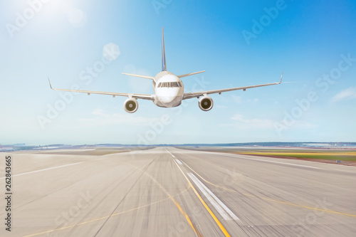 The flight of the aircraft over the runway at the airport.