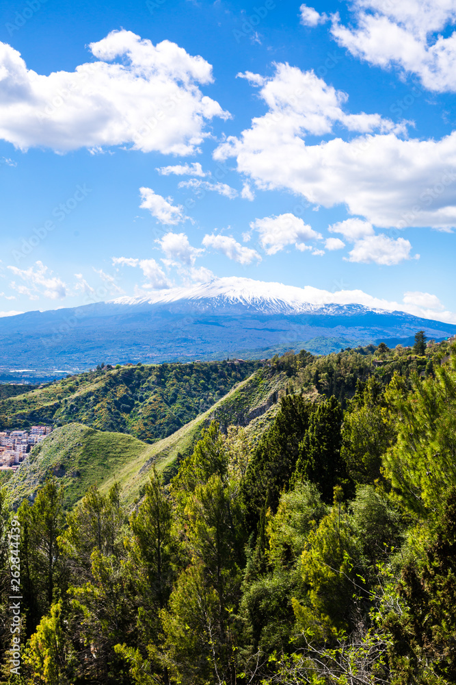 Etna volcano (vulcano) view, Sicily island, Italy. Bright summer sky with clouds. 