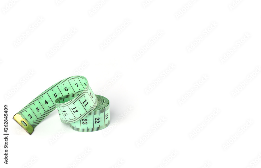 Tailoring centimeter tape twisted into a spiral isolated on a white background. Tailoring centimeter tape twisted into a spiral isolated on a white background.