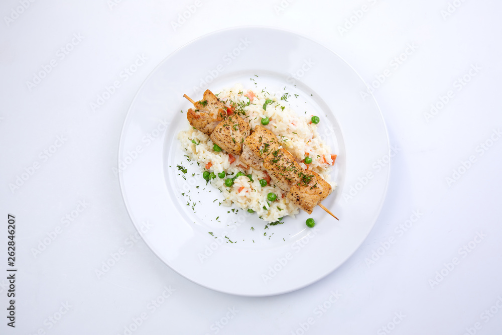 chicken kebab with rice and vegetables on the white background chicken kebab with rice and vegetables on the white background