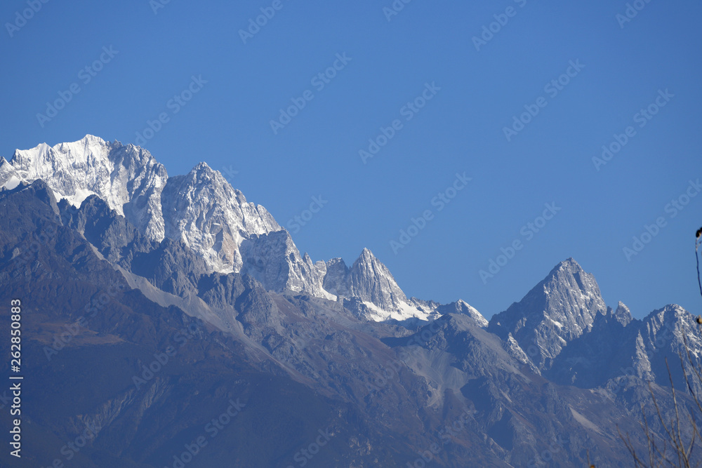 View of the snow-capped peaks of the Jade Dragon Snow Mountain. The mountain overlooking the city of Lijiang, Yunnan, China