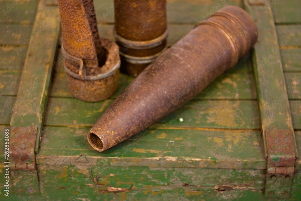 The old artillery shells lie in wooden box