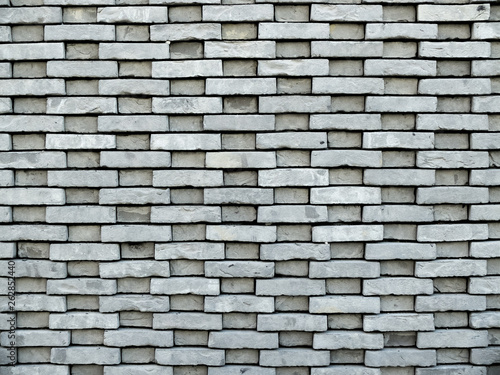 mur de briques grises rectangulaires avec reliefs apparents