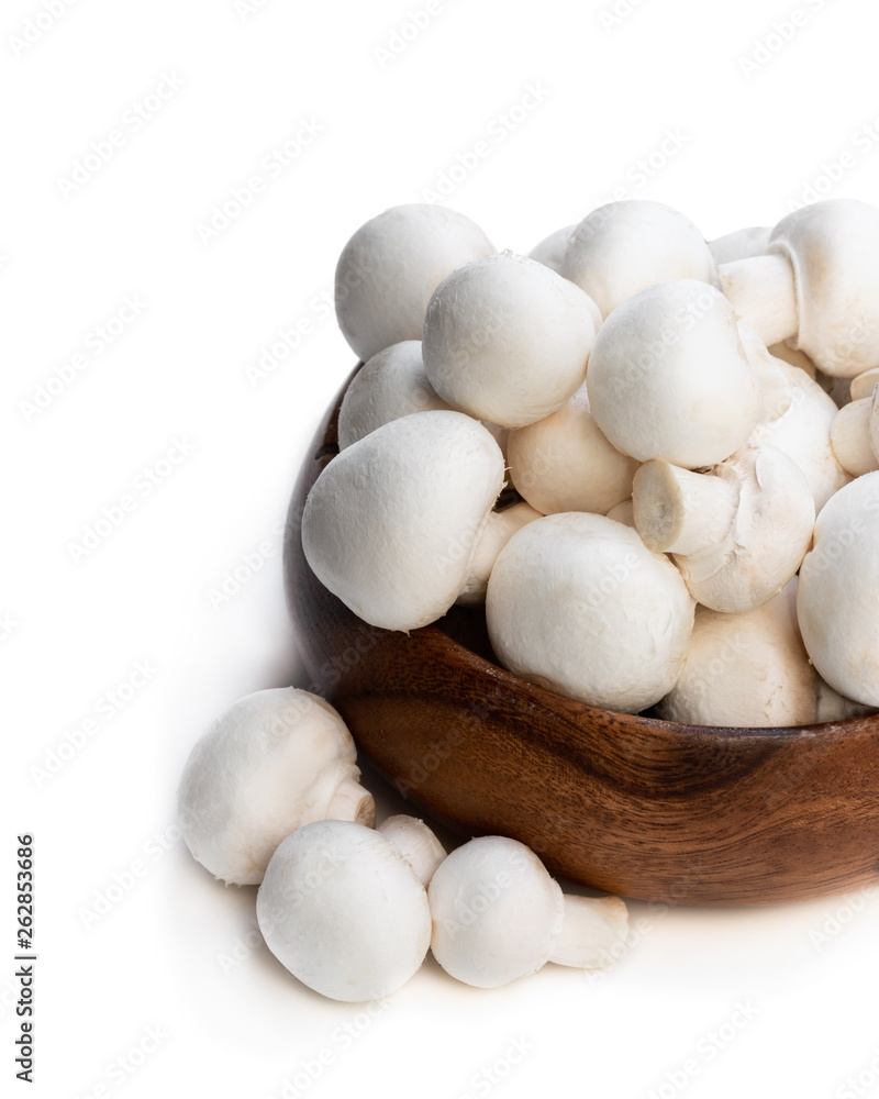Fresh mushrooms in wooden bowl isolated on white Fresh mushrooms in wooden bowl isolated on white