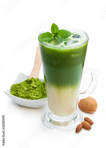 Homemade layered iced matcha latte tea with almond milk isolated on white