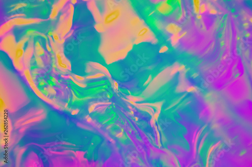 Abstract trendy holographic background in 80s style. Real texture in violet, pink and mint colors with scratches and irregularities. Synthwave. Vaporwave style. Retrowave, retro futurism, webpunk