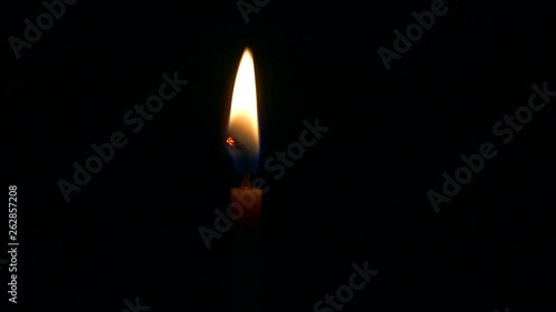 Candle light on, fire burning in dark room, isolated in black background