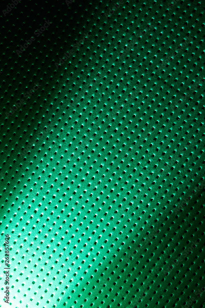 Diagonal bright diffused beam of light on a green background in a black dot Diagonal bright diffused beam of light on a green background in a black dot