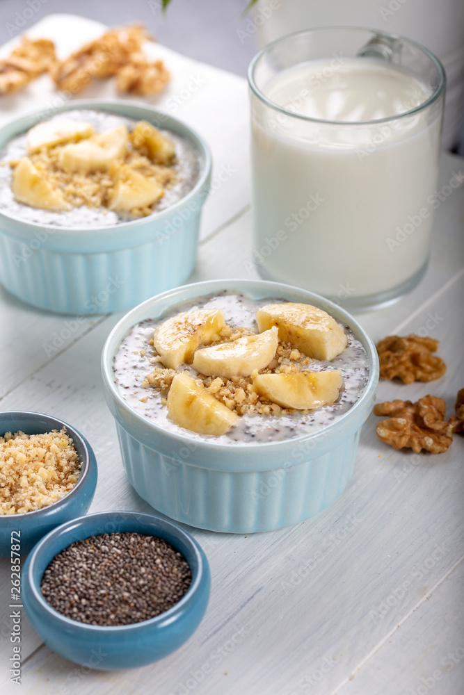 Chia pudding made with milk, banana and decorated with walnut Chia pudding made with milk, banana and decorated with walnut