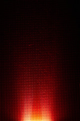 Unusual ray of light on a red background in a black dot