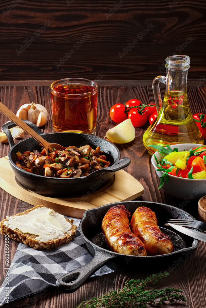 Obraz premium Vegetarian food. Fried mushrooms and egg in cast iron pan. Ingredients for rustic breakfast on wooden table.