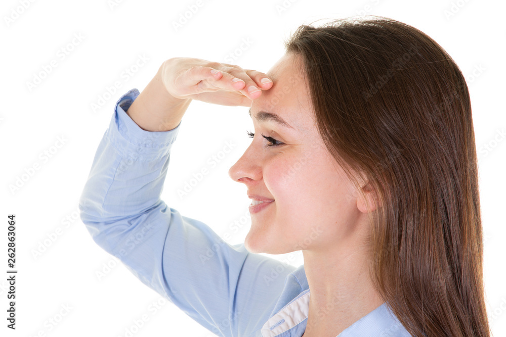 Cheerful young woman is trying to see something hand forehead Cheerful young woman is trying to see something hand forehead