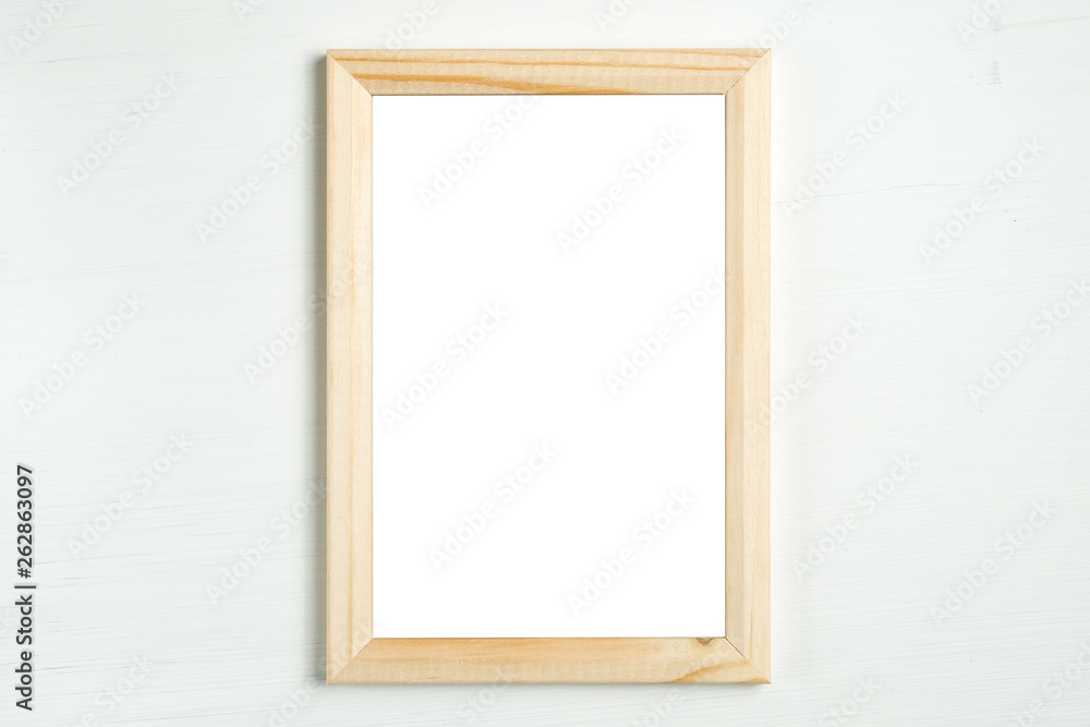 Rectangular wooden vertical frame on a white wooden background. Rectangular wooden vertical frame on a white wooden background.