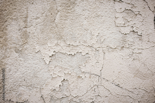 Gray cement wall with traces of the brush on the crumbling plaster. textural composition