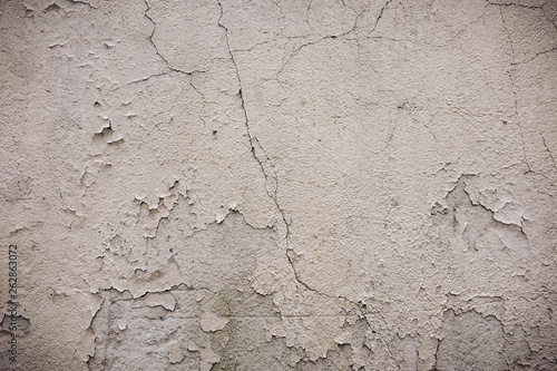 Gray cement wall with traces of the brush on the crumbling plaster. textural composition