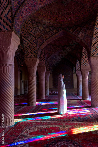 Anonymous woman inside of colorful oriental mosque photo