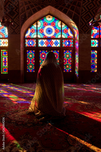 Anonymous woman inside of colorful oriental mosque photo