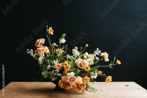Florist in studio building a stunning floral arrangement photo